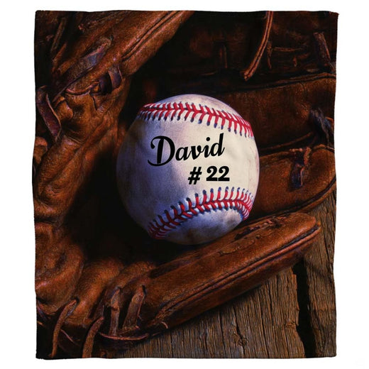 Rustic wood baseball throw blanket featuring baseball inside fielding mitt on weathered timber planks