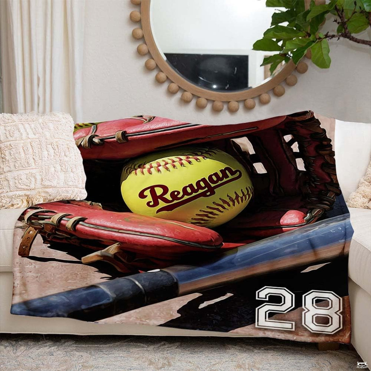 Red glove fastpitch artwork blanket styled across modern couch