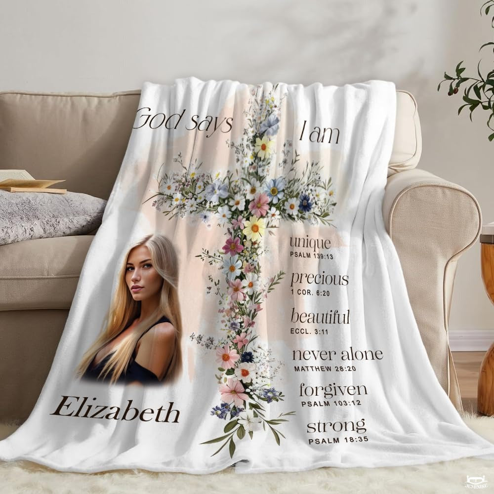 Inspirational floral cross scripture blanket styled over couch in bright natural living room.