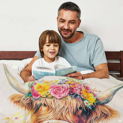 Close up of Highland cow throw blanket highlighting pink roses, buttercups, and detailed cow fur