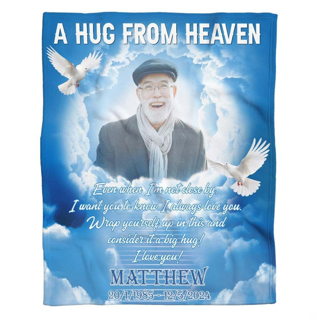 Flat view of hug from heaven memorial blanket featuring flying white doves and cloud formations across a blue sky