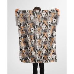 Person holding up a repeating Greyhound canine blanket against a plain background.