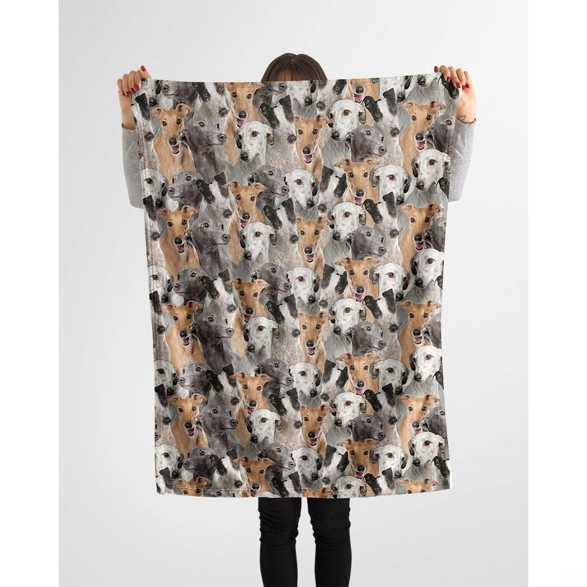 Person holding up a repeating Greyhound canine blanket against a plain background.