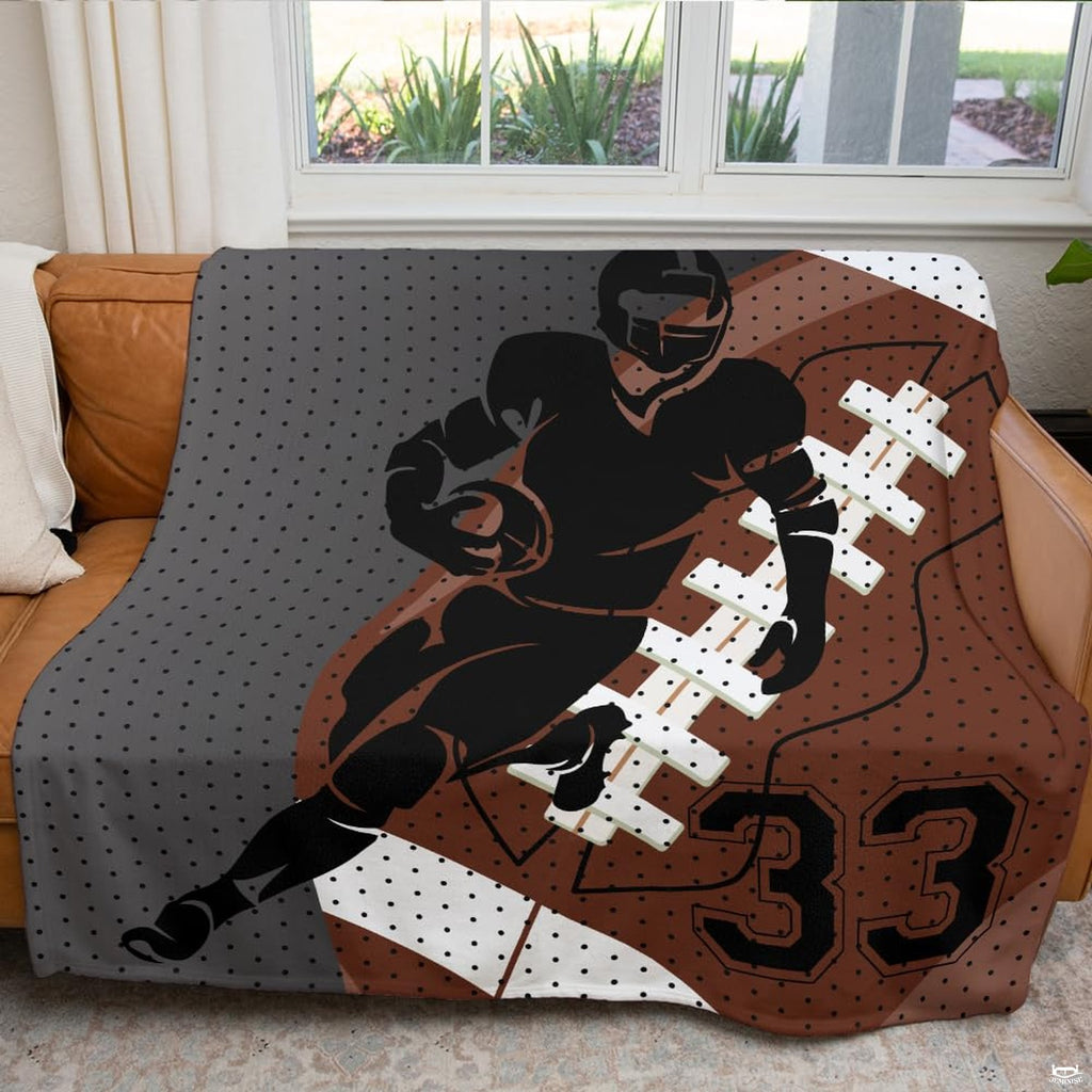 Close-up of diagonal field line graphics, white laces, and athletic typography on football themed bedding.