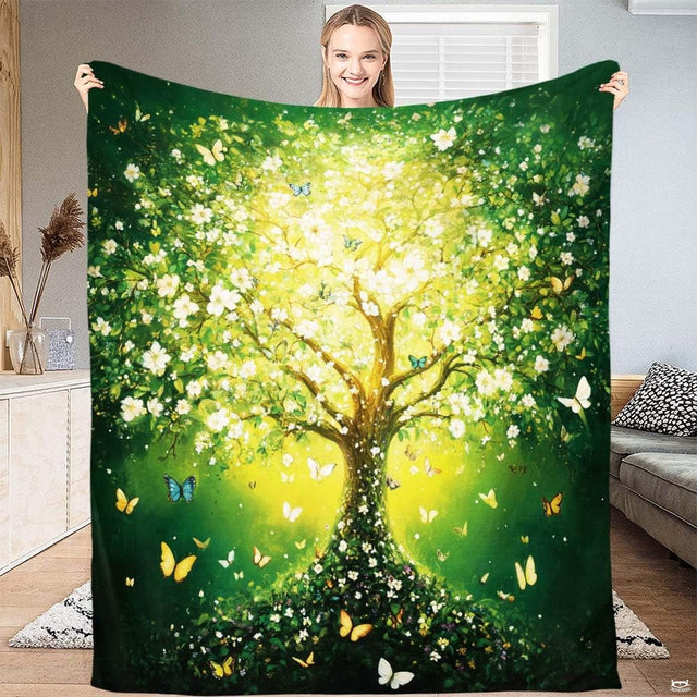 Luminous Tree of Life butterfly throw blanket held open by woman