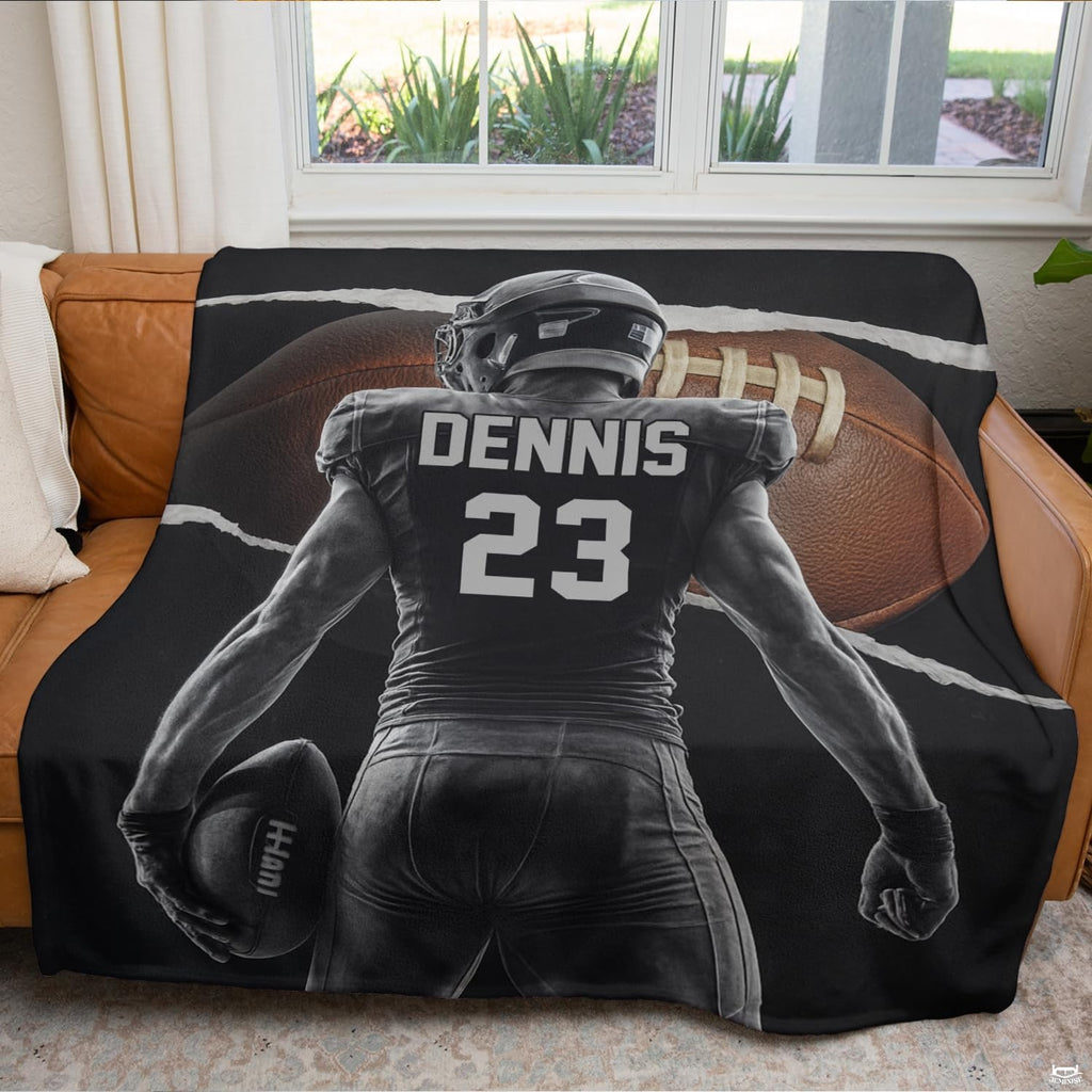 Torn paper football athlete textile arranged across living room sofa