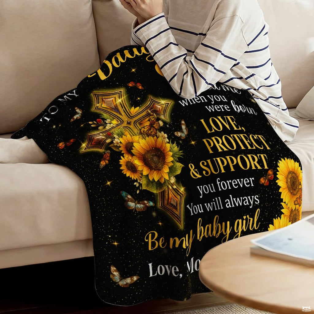 Detail of golden yellow sunflowers, shimmering stardust, and devotional lettering on a blanket