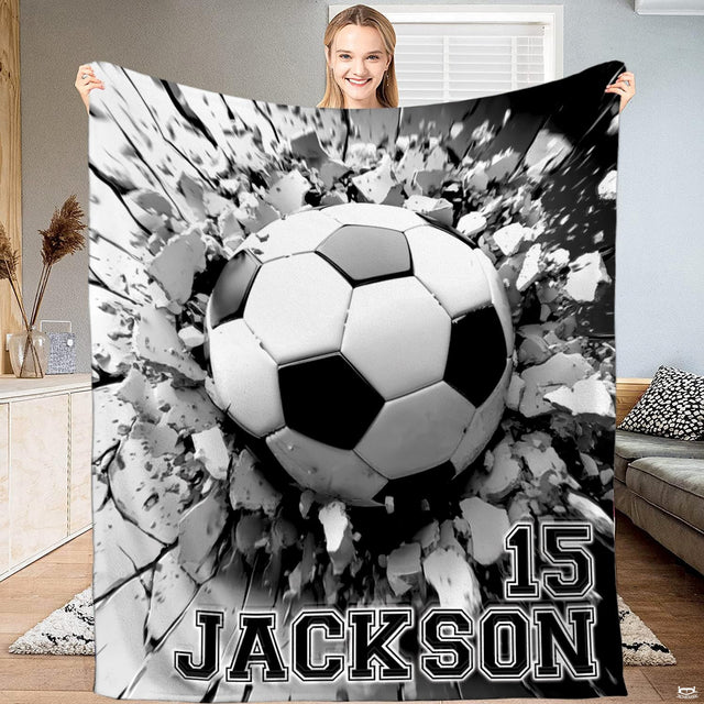 Monochrome 3D soccer ball bursting through shattered concrete wall throw blanket