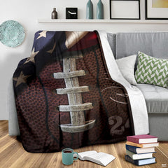Patriotic vintage football blanket displayed on living room armchair