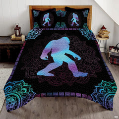 Cyan moonlit Bigfoot Sasquatch woodland bedding set displayed on a bed in a rustic mountain lodge