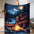 Bigfoot campfire beer mountain throw blanket featuring Sasquatch with drink by fire under alpine moon