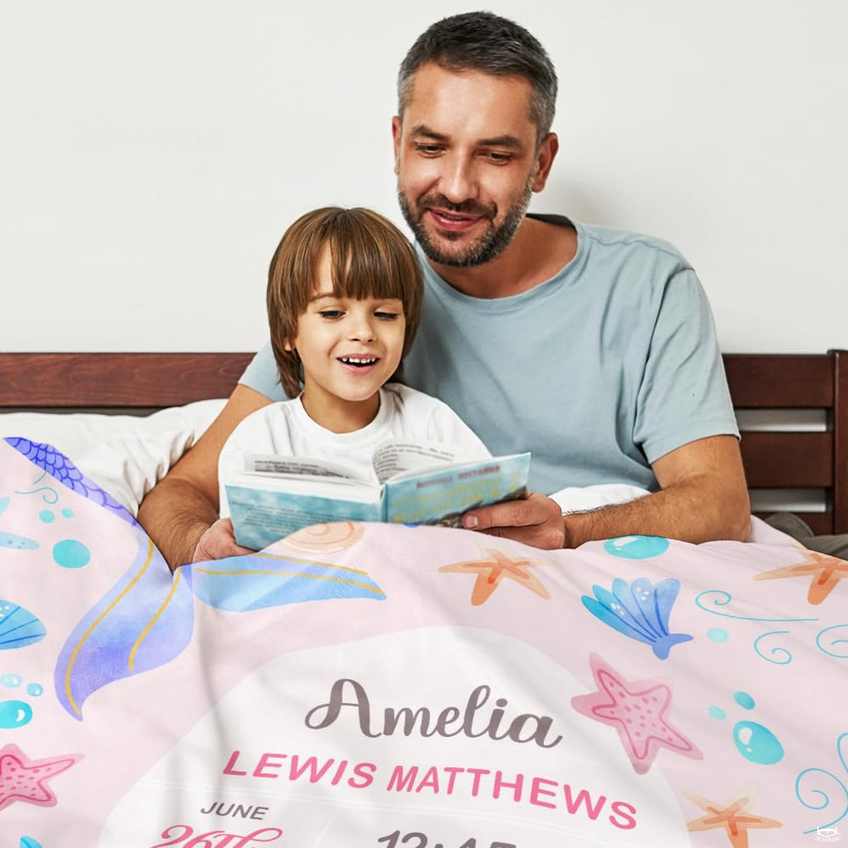 Overhead presentation of pink watercolor mermaid tails blanket