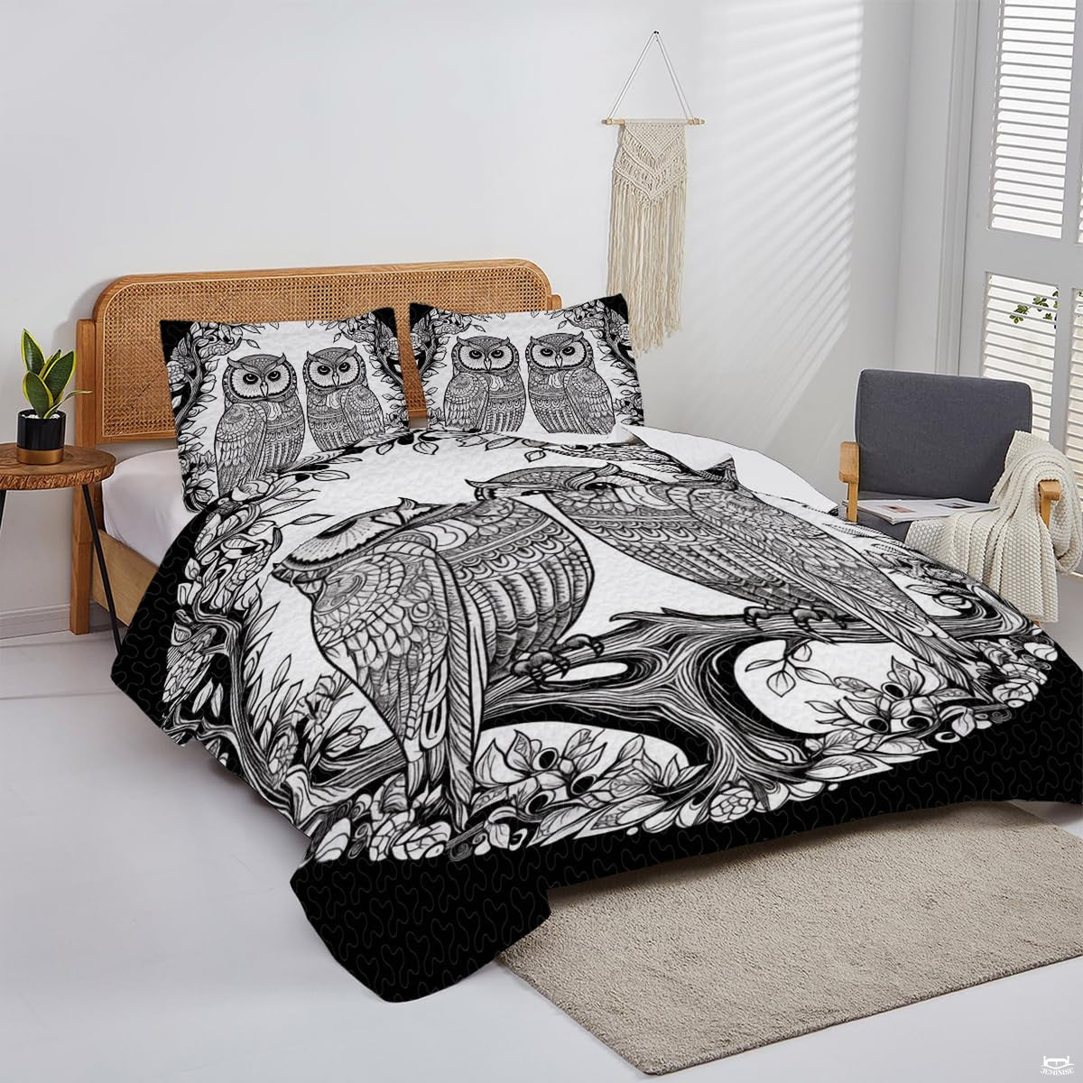 Overhead perspective of snowy owl bedding arranged neatly across a mattress with winter room decor