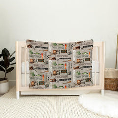 Detailed view of fishing vest, lure graphics, and pine branches on fishing theme bedding.