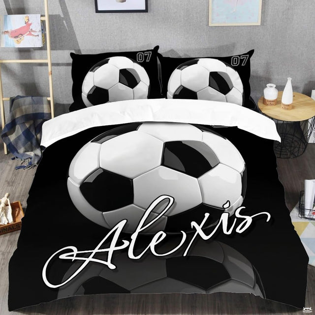 Top-down view of monochrome black and white football bedding set arranged neatly on a youth bedroom mattress