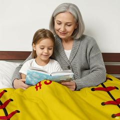 Two people reading in bed with optic yellow sports design spread across them.