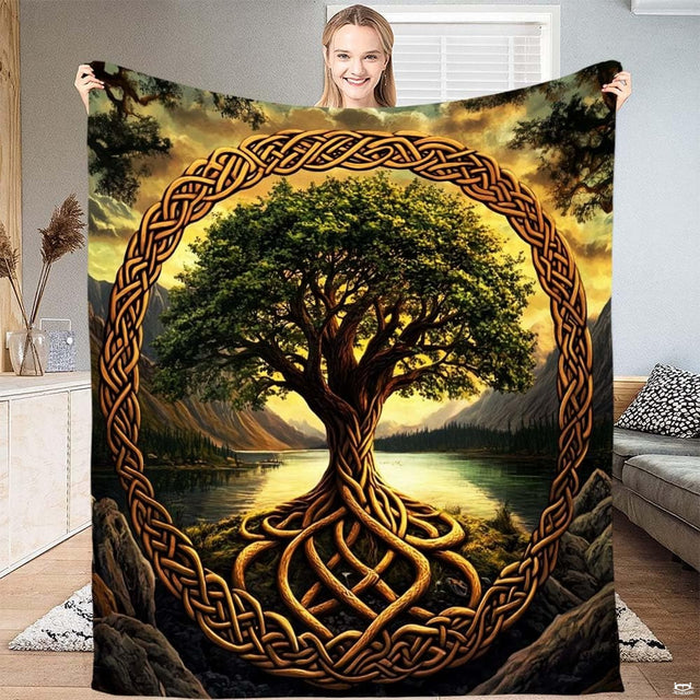 Model displaying Celtic knot ring tree of life throw blanket with mountain lake landscape at sunset