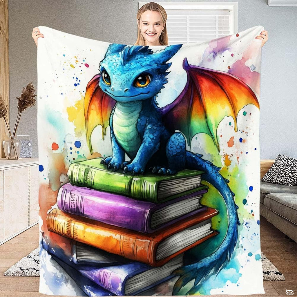 Cute baby dragon throw blanket showing watercolor blue dragon with rainbow wings on books.