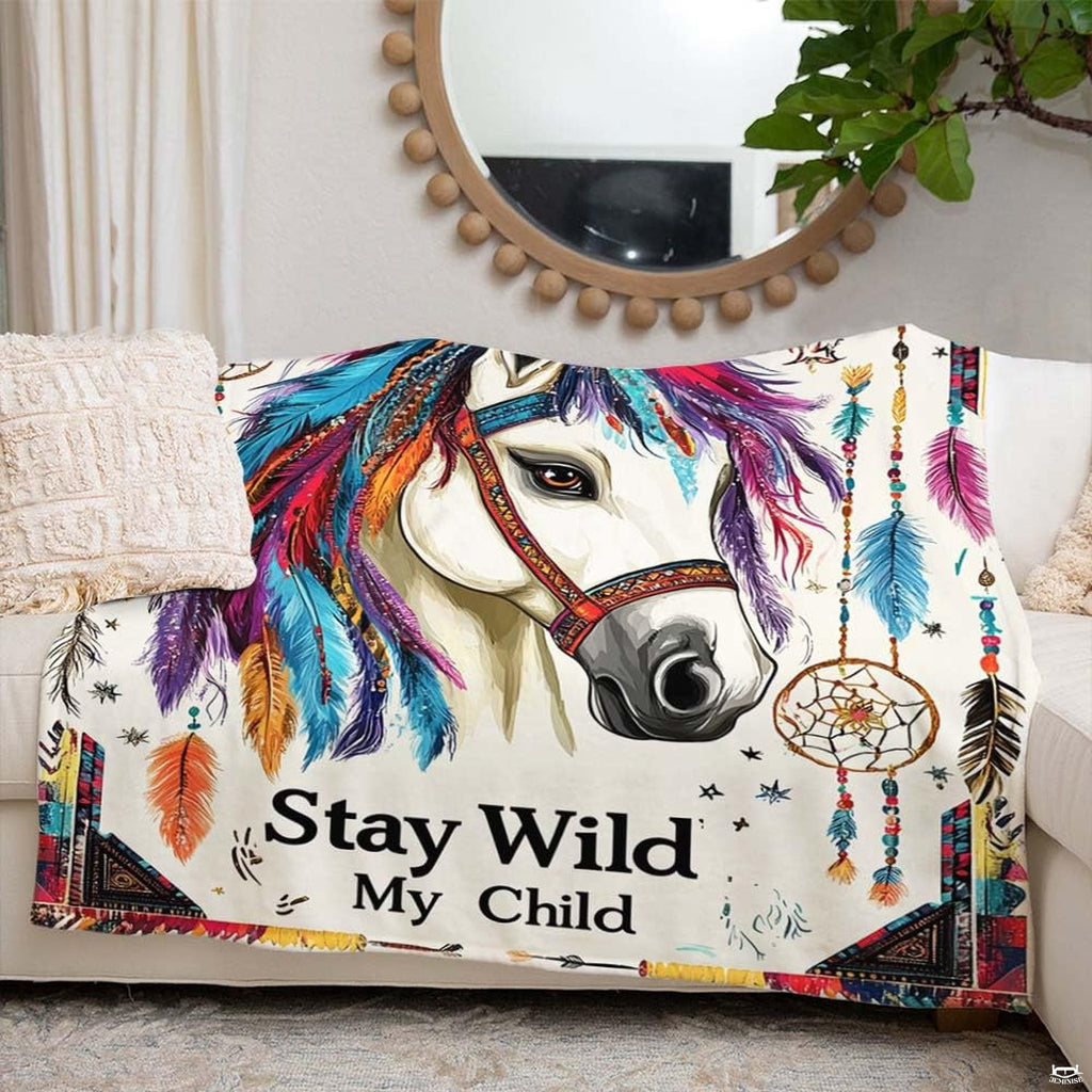 Woman holding open boho tribal feathers horse throw blanket in modern living room