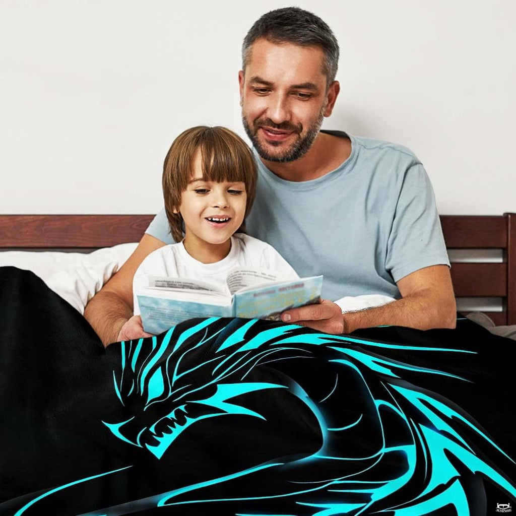 Neatly folded electric cyan dragon throw blanket displayed on wooden surface showcasing clean edge borders