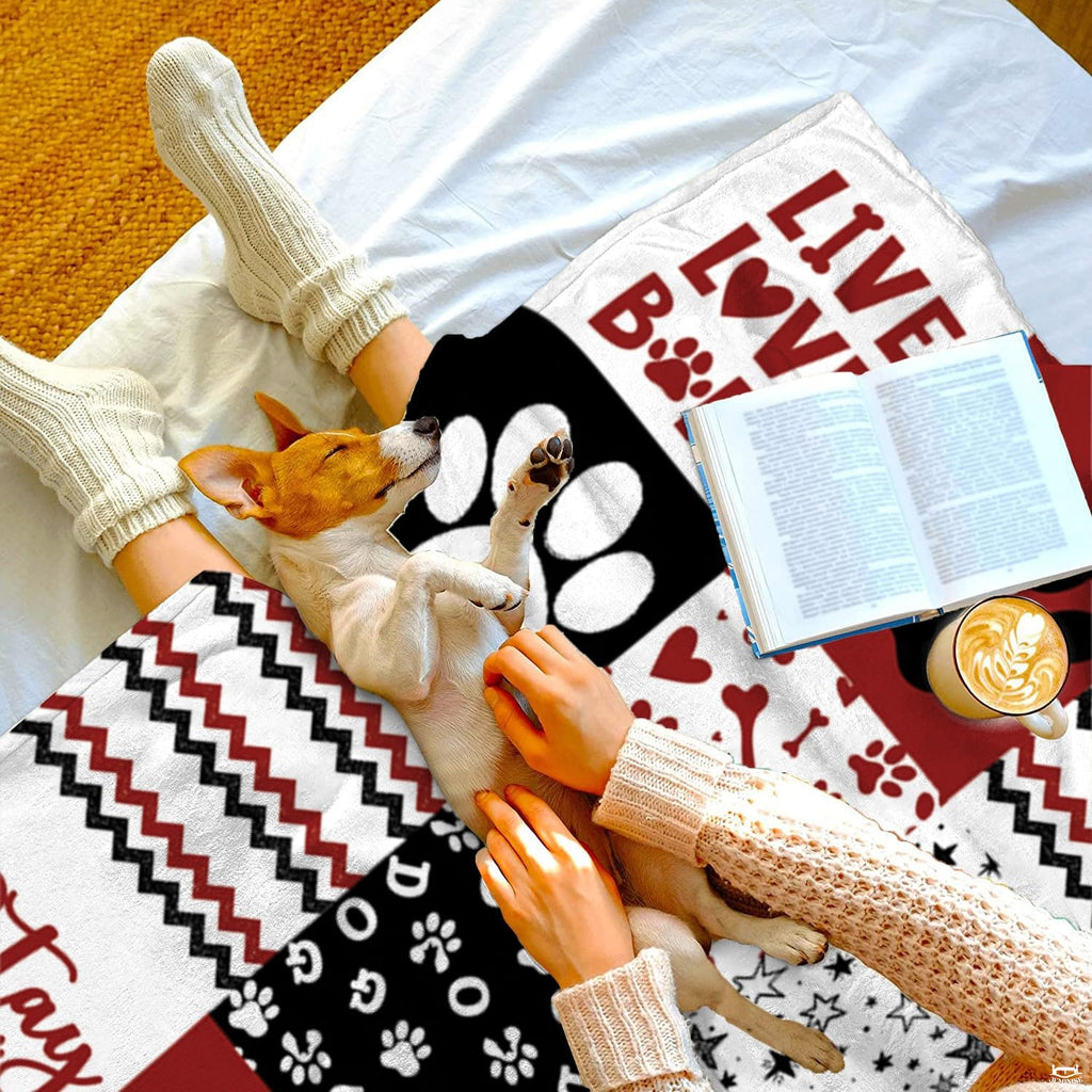 Graphic collage design on dog paw print bedding highlighting crisp white paw outlines on black and crimson backgrounds.