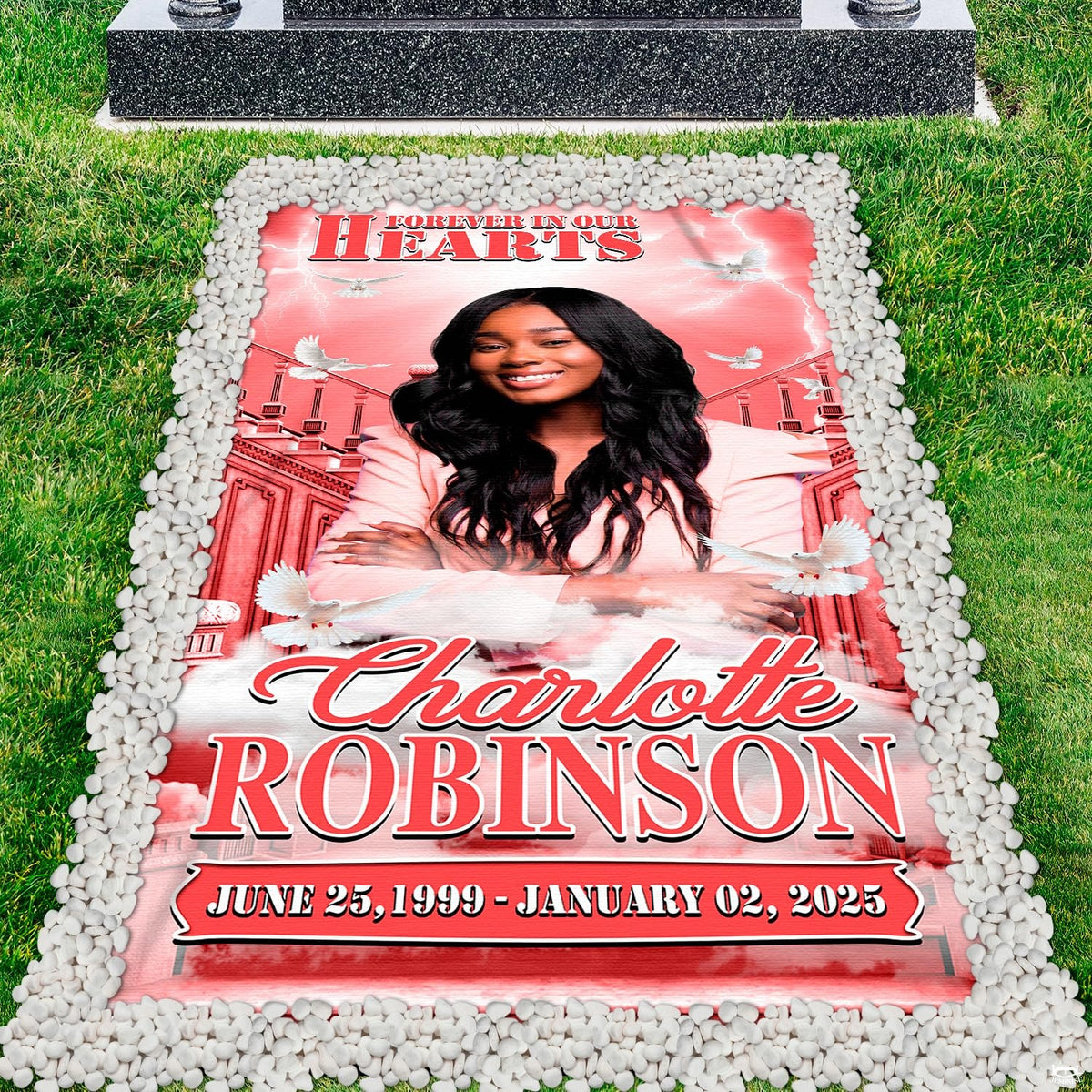 Memorial grave blanket installed on lawn grave marker bordered by clean white river stones