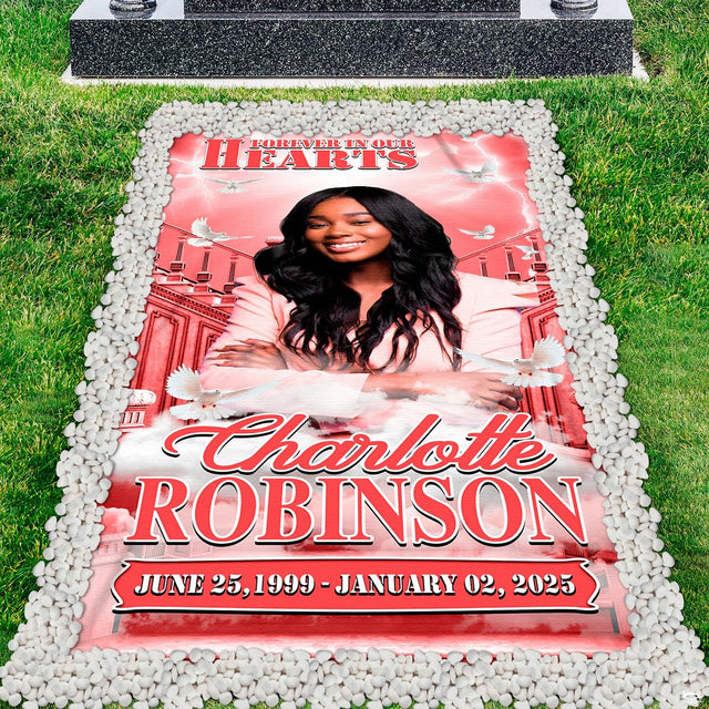 Memorial grave blanket installed on lawn grave marker bordered by clean white river stones