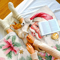 Close-up of pink Christmas bedding double showing Santa Claus and candy cane watercolor graphics.
