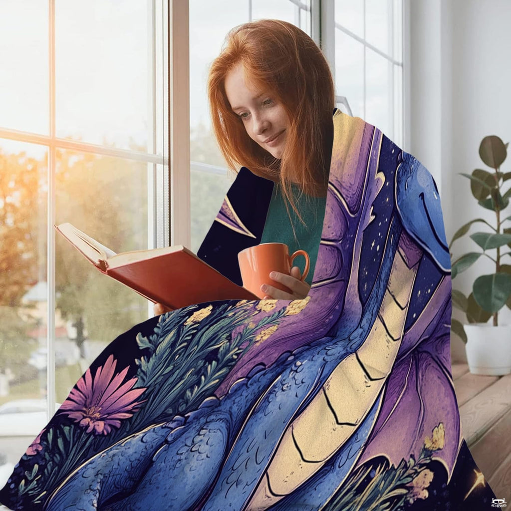 Enchanting baby blue dragon and night meadow throw blanket styled in a peaceful bedroom.