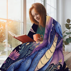 Enchanting baby blue dragon and night meadow throw blanket styled in a peaceful bedroom.