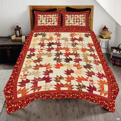 Autumn maple leafs bedding set featuring geometric pinwheel leaf patchwork in rich crimson, orange, and gold tones.