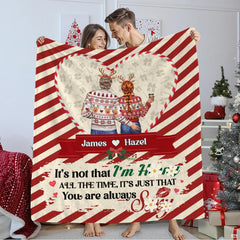 Holiday couple inside candy cane heart frame on diagonal peppermint stripes, view 1.
