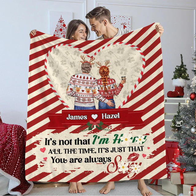 Holiday couple inside candy cane heart frame on diagonal peppermint stripes, view 1.
