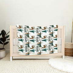 Rustic bedroom styled with forest green pine and deer illustration bedding.