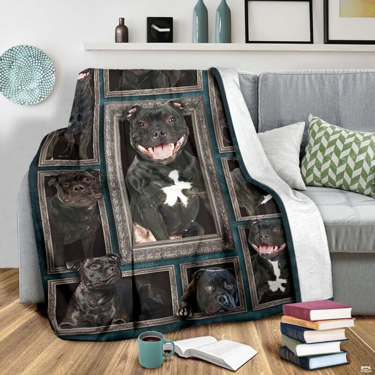 Grey couch arrangement featuring the Staffordshire Bull Terrier blanket draped beside patterned pillows.