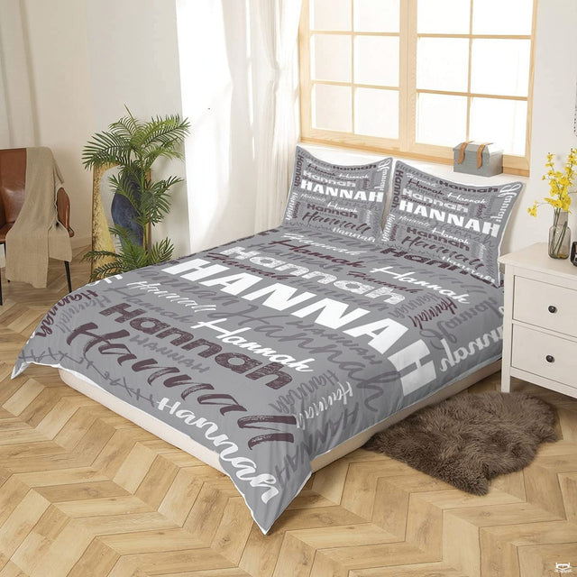 Close-up of decorative script and charcoal lettering pattern across modern bedding set.