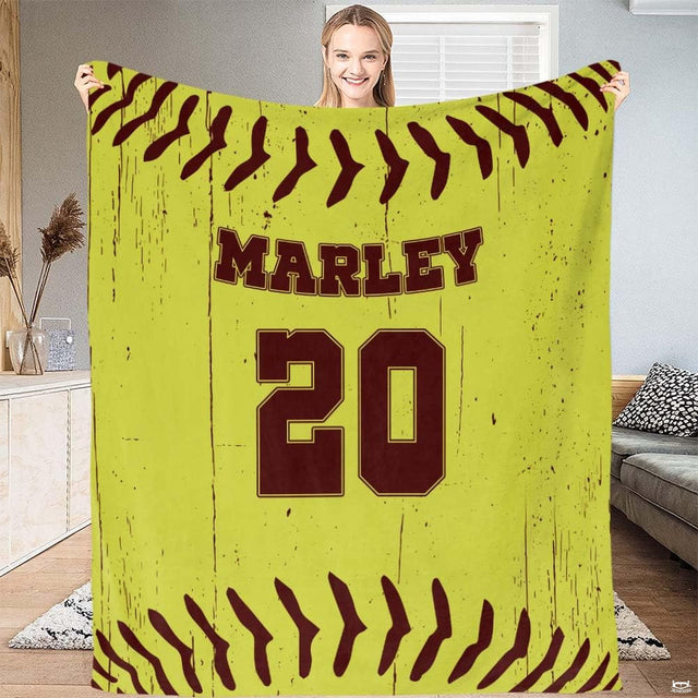 Woman holding distressed fastpitch optic surface blanket in living room