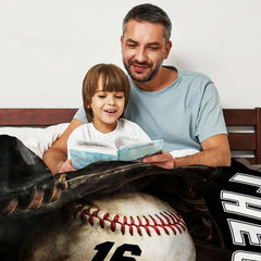 Baseball resting inside a dark fielder glove beside vertical white varsity lettering, view 3.
