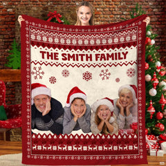 Nordic Fair Isle Christmas family holiday blanket held before festive tree