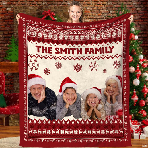 Nordic Fair Isle Christmas family holiday blanket held before festive tree