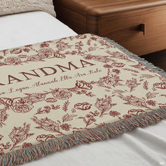 Detailed view of central oval wreath garland and elegant typography on Blanket.