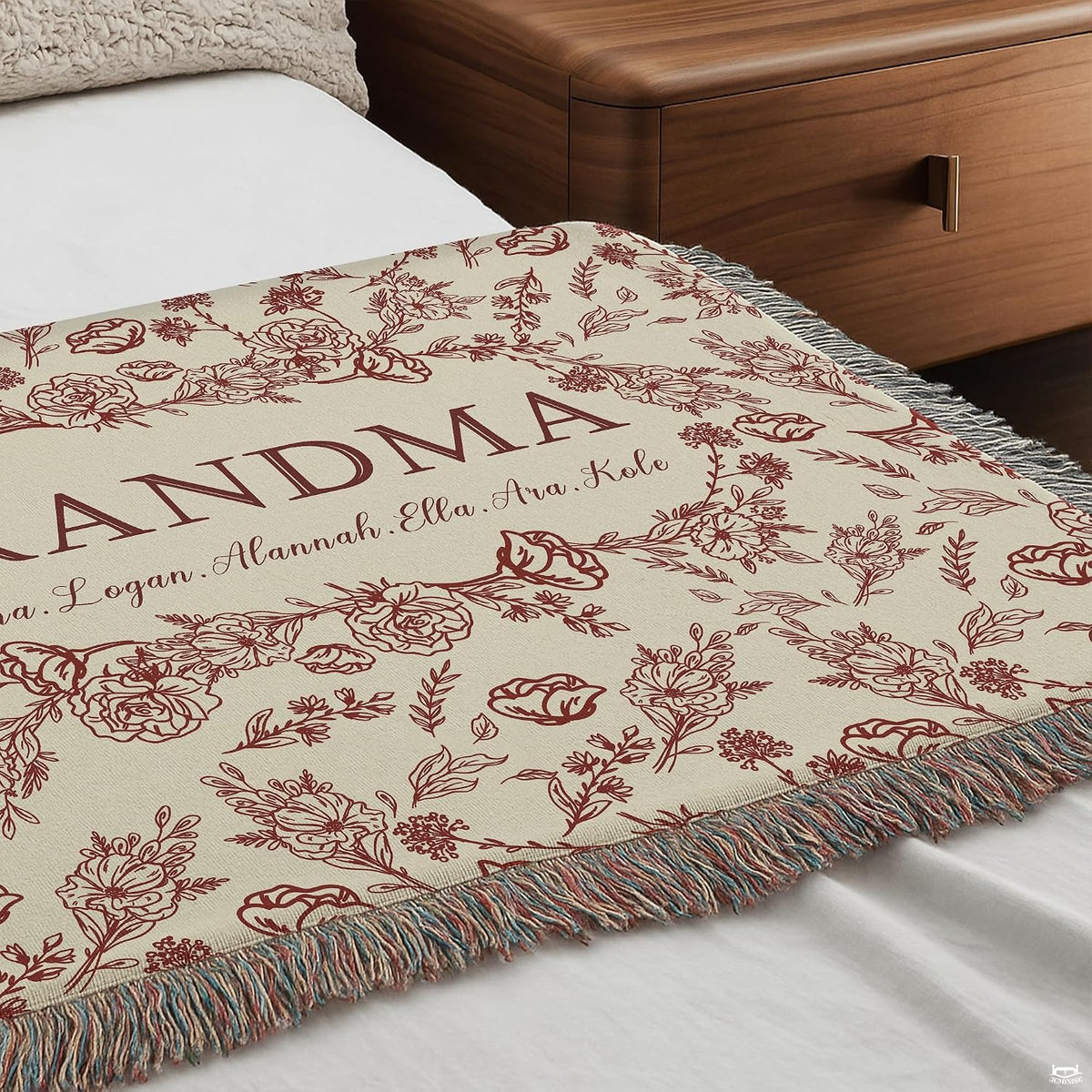 Detailed view of central oval wreath garland and elegant typography on Blanket.