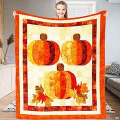 Charming trio pumpkin throw blanket draped across living room armchair