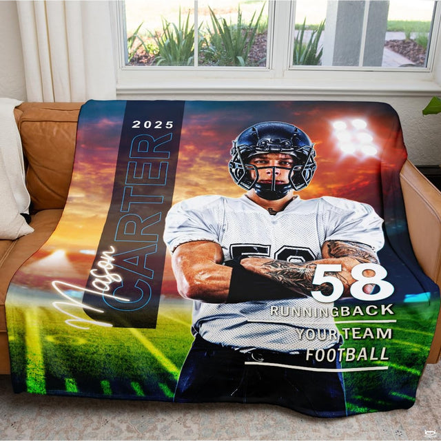 Football player graphic throw blanket draped neatly over brown leather sofa in well lit living room.