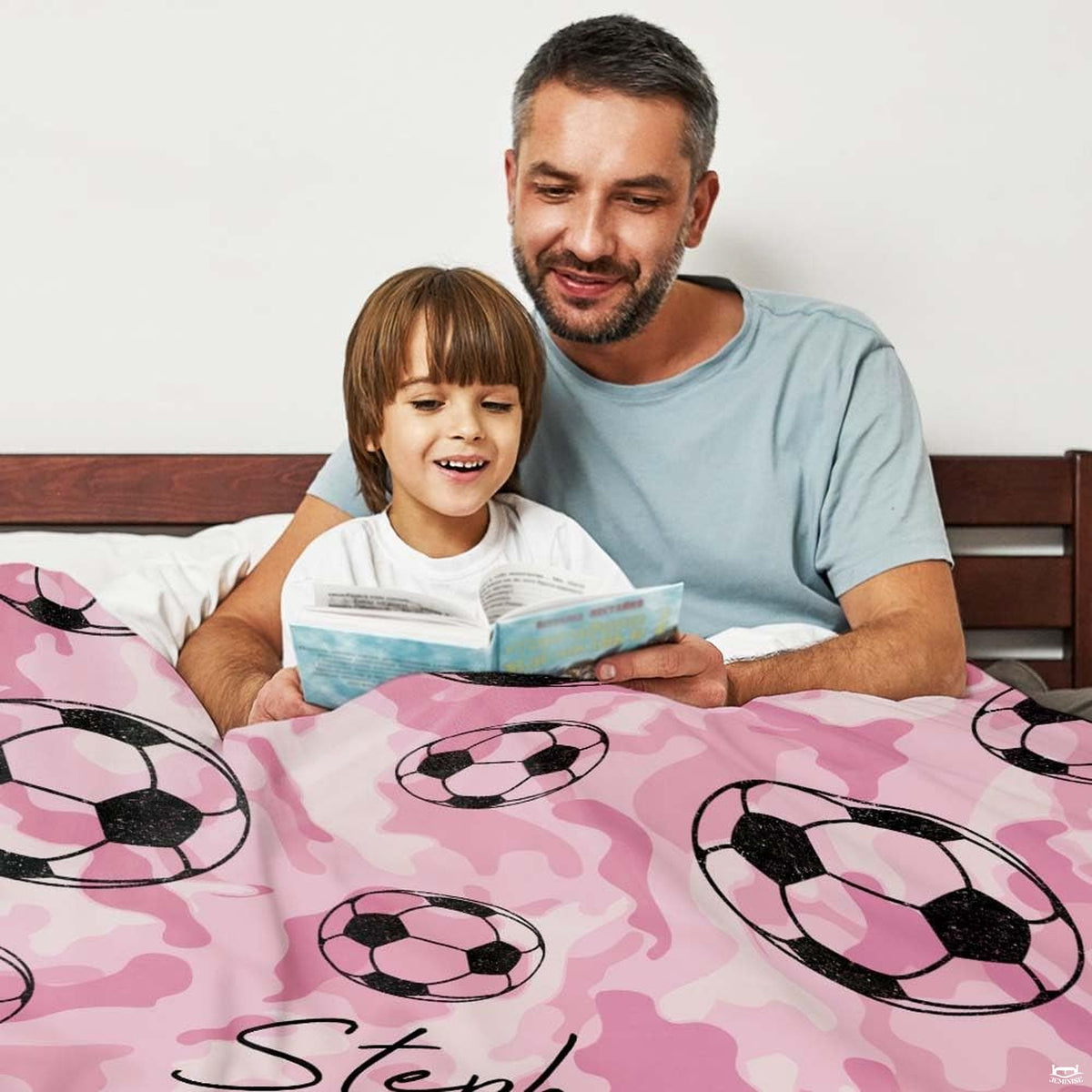 Soccer balls pink camo artwork blanket folded on living room chair