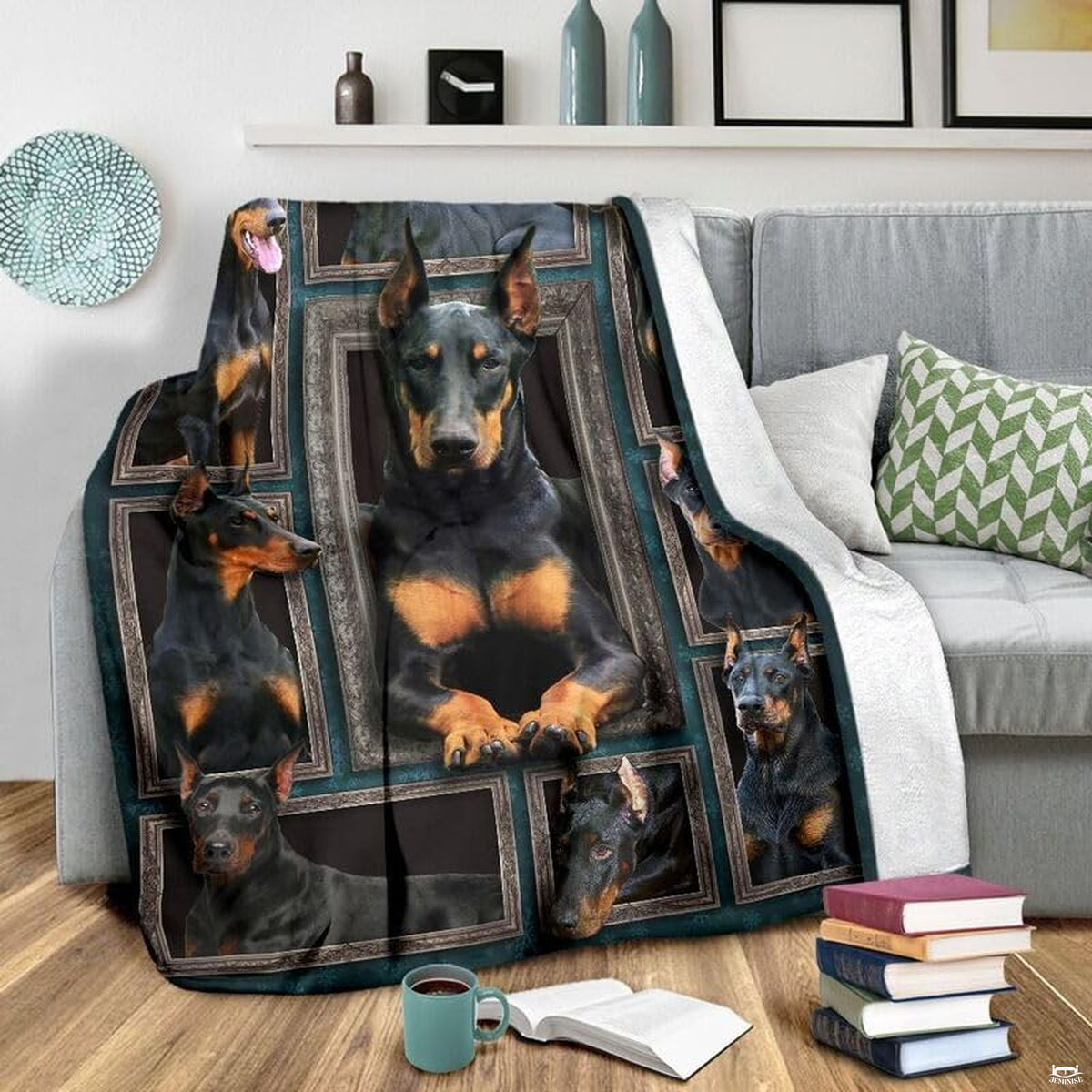 Grey couch arrangement featuring the Doberman Pinscher blanket draped beside patterned pillows.