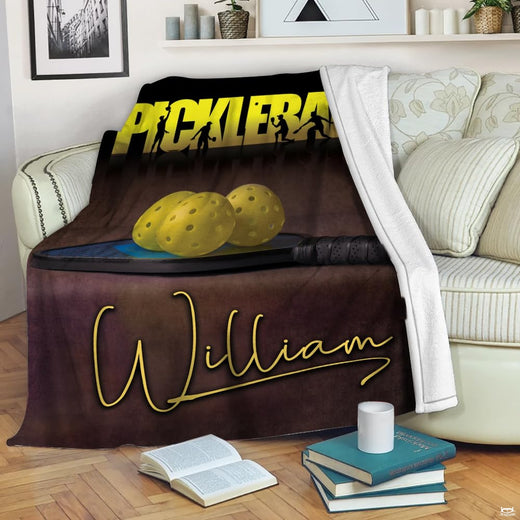 Retro pickleball paddle ball throw blanket featuring yellow perforated balls on paddle with player silhouettes