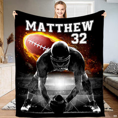 Football center lineman flaming ball throw blanket displaying an athlete over the ball with roaring fire graphics