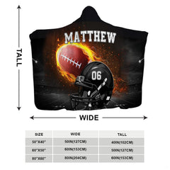 Flaming football helmet stadium throw blanket held open showing dramatic night game field backdrop