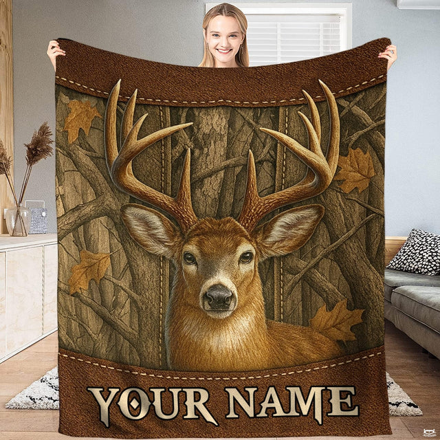 Whitetail buck rustic hunter blanket featuring deer portrait on woodgrain paneling with oak leaves.